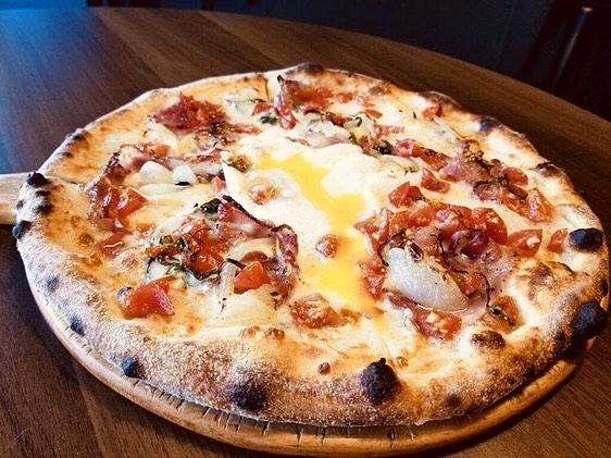 Wood-fired pizza being prepared